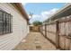 Large backyard with gravel pathway, wooden fence, and detached building at 3909 W Sligh Ave, Tampa, FL 33614