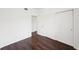 Bedroom with dark brown laminate flooring and double door closet at 3909 W Sligh Ave, Tampa, FL 33614