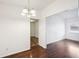 Dining area with dark brown laminate flooring and chandelier at 3909 W Sligh Ave, Tampa, FL 33614