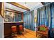Home bar with dark wood cabinetry, leather stools, and elegant decor at 425 20Th Ne Ave, St Petersburg, FL 33704