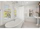 Elegant bathroom with a clawfoot tub, shower, and white tile flooring at 425 20Th Ne Ave, St Petersburg, FL 33704