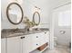 Double vanity bathroom with granite countertops and white cabinets at 425 20Th Ne Ave, St Petersburg, FL 33704