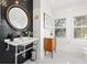 Stylish bathroom with hexagon tile, a modern vanity, and a round mirror at 425 20Th Ne Ave, St Petersburg, FL 33704