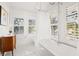 Elegant bathroom featuring a clawfoot tub, window shutters, and a patterned floor at 425 20Th Ne Ave, St Petersburg, FL 33704
