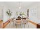 Bright dining room with hardwood floors, modern light fixture, and seating for six at 425 20Th Ne Ave, St Petersburg, FL 33704