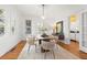 Bright dining room with hardwood floors, modern light fixture, and kitchen access at 425 20Th Ne Ave, St Petersburg, FL 33704