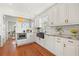 White kitchen with hardwood floors, island, and stainless steel appliances at 425 20Th Ne Ave, St Petersburg, FL 33704
