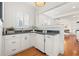 White kitchen with a built in bar and mini fridge at 425 20Th Ne Ave, St Petersburg, FL 33704