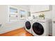 Bright laundry room with washer, dryer, and hardwood floors at 425 20Th Ne Ave, St Petersburg, FL 33704