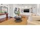Living room with built-in shelving and a large TV at 425 20Th Ne Ave, St Petersburg, FL 33704