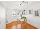 Home office with hardwood floors, a white desk, and a stylish light fixture at 425 20Th Ne Ave, St Petersburg, FL 33704
