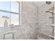 Large shower with marble tile and built-in bench seat at 425 20Th Ne Ave, St Petersburg, FL 33704