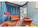 Charming sitting room with leather chairs, antique sofa, and blue velvet curtains at 425 20Th Ne Ave, St Petersburg, FL 33704