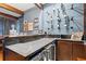 Home bar with wine storage, stone countertop, and dark wood cabinets at 425 20Th Ne Ave, St Petersburg, FL 33704