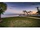 Serene backyard with sunset views, lush grass, and private dock at 4419 Bayshore Ne Blvd, St Petersburg, FL 33703