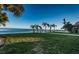 Scenic backyard with lush grass, palm trees, and waterfront views at 4419 Bayshore Ne Blvd, St Petersburg, FL 33703