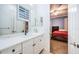 Bathroom with white cabinets, quartz countertop, and a view of bedroom at 4419 Bayshore Ne Blvd, St Petersburg, FL 33703