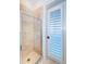 Clean bathroom with beige tile, a shower stall, and a door to the outside at 4419 Bayshore Ne Blvd, St Petersburg, FL 33703