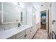 Modern bathroom with white cabinets, quartz countertops, and a large mirror at 4419 Bayshore Ne Blvd, St Petersburg, FL 33703