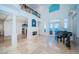 Elegant entryway features water views, fireplace, and grand piano at 4419 Bayshore Ne Blvd, St Petersburg, FL 33703