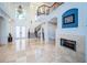 Bright two story entryway with marble floors, fireplace, and curved staircase at 4419 Bayshore Ne Blvd, St Petersburg, FL 33703