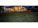 Back view of luxury home with lights on at night at 4419 Bayshore Ne Blvd, St Petersburg, FL 33703