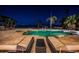 Inviting pool area with lounge chairs, overlooking the water at night at 4419 Bayshore Ne Blvd, St Petersburg, FL 33703