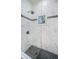Clean shower with glass enclosure and marble tile at 4419 Bayshore Ne Blvd, St Petersburg, FL 33703