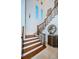 Elegant wooden staircase with wrought iron railings and a large statue at 4419 Bayshore Ne Blvd, St Petersburg, FL 33703