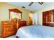 Bedroom with wooden dresser and a comfortable bed, near closet at 4728 Swallowtail Dr, New Port Richey, FL 34653