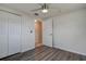 Simple bedroom with wood-look floors and ceiling fan at 5280 87Th N Ter, Pinellas Park, FL 33782