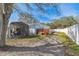 Backyard view showcasing a metal carport, fenced yard, and shed at 5885 110Th N Ave, Pinellas Park, FL 33782