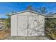 White metal storage shed with double doors at 5885 110Th N Ave, Pinellas Park, FL 33782