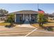 Community clubhouse featuring a flag and palm trees at 5909 Yorkshire Dr, Zephyrhills, FL 33542