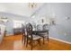 Dining room with hardwood floors and decorative chandelier at 5909 Yorkshire Dr, Zephyrhills, FL 33542