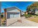 Double-car garage with concrete driveway and landscaping at 5909 Yorkshire Dr, Zephyrhills, FL 33542