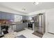 Modern kitchen with gray cabinets, stainless steel appliances, and granite countertops at 5909 Yorkshire Dr, Zephyrhills, FL 33542