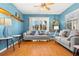 Living room with hardwood floors, light blue walls, and comfy seating at 5909 Yorkshire Dr, Zephyrhills, FL 33542