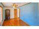 Bedroom with blue walls, hardwood floors, and built-in shelves at 616 2Nd Nw Ave, Largo, FL 33770