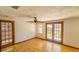 Spacious bedroom with wood floors, ceiling fan, and French doors at 616 2Nd Nw Ave, Largo, FL 33770