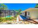 Relaxing backyard with a screened pool and adjacent deck at 616 2Nd Nw Ave, Largo, FL 33770