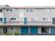 Exterior view of building with teal garages below at 6325 Newtown Cir # 25B2, Tampa, FL 33615