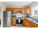 Galley kitchen with stainless steel appliances and wood cabinets at 6325 Newtown Cir # 25B2, Tampa, FL 33615