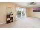 Bright living room with balcony access and city views at 6325 Newtown Cir # 25B2, Tampa, FL 33615