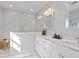 Modern bathroom with double vanity, marble countertop, and a spacious glass-enclosed shower at 6605 24Th S Ave, Tampa, FL 33619