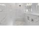 Spa-like shower with marble walls and floor, and modern fixtures at 6605 24Th S Ave, Tampa, FL 33619