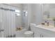 Stylish bathroom showcasing a tub with shower, white vanity, and modern fixtures at 6605 24Th S Ave, Tampa, FL 33619
