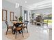 Bright dining room area with modern table, stylish seating, natural light, and decorative wall hangings at 6605 24Th S Ave, Tampa, FL 33619
