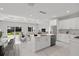 Modern kitchen with white cabinets, a center island, and marble floors at 6605 24Th S Ave, Tampa, FL 33619