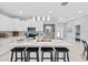 Modern open-concept kitchen features a large center island with sleek white cabinets, stainless appliances at 6605 24Th S Ave, Tampa, FL 33619